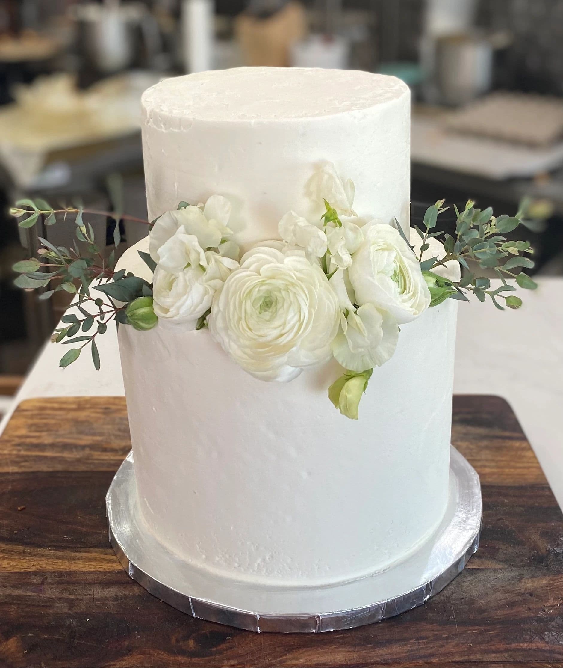 Beautiful wedding cake with white ranunculus